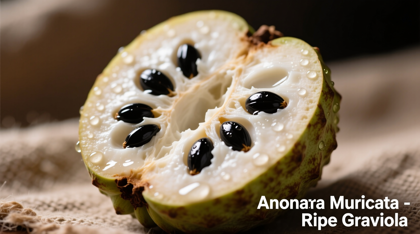 Ripe graviola fruit cut open showing creamy white flesh and black seeds