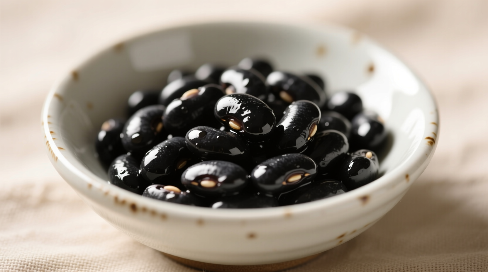 Perfectly cooked black beans in a white ceramic bowl