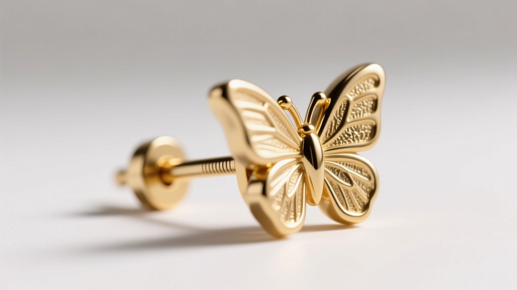 Macro view of an 18k gold earring post and butterfly backing, highlighting deep friction notches and precise 0.9mm thickness gauge