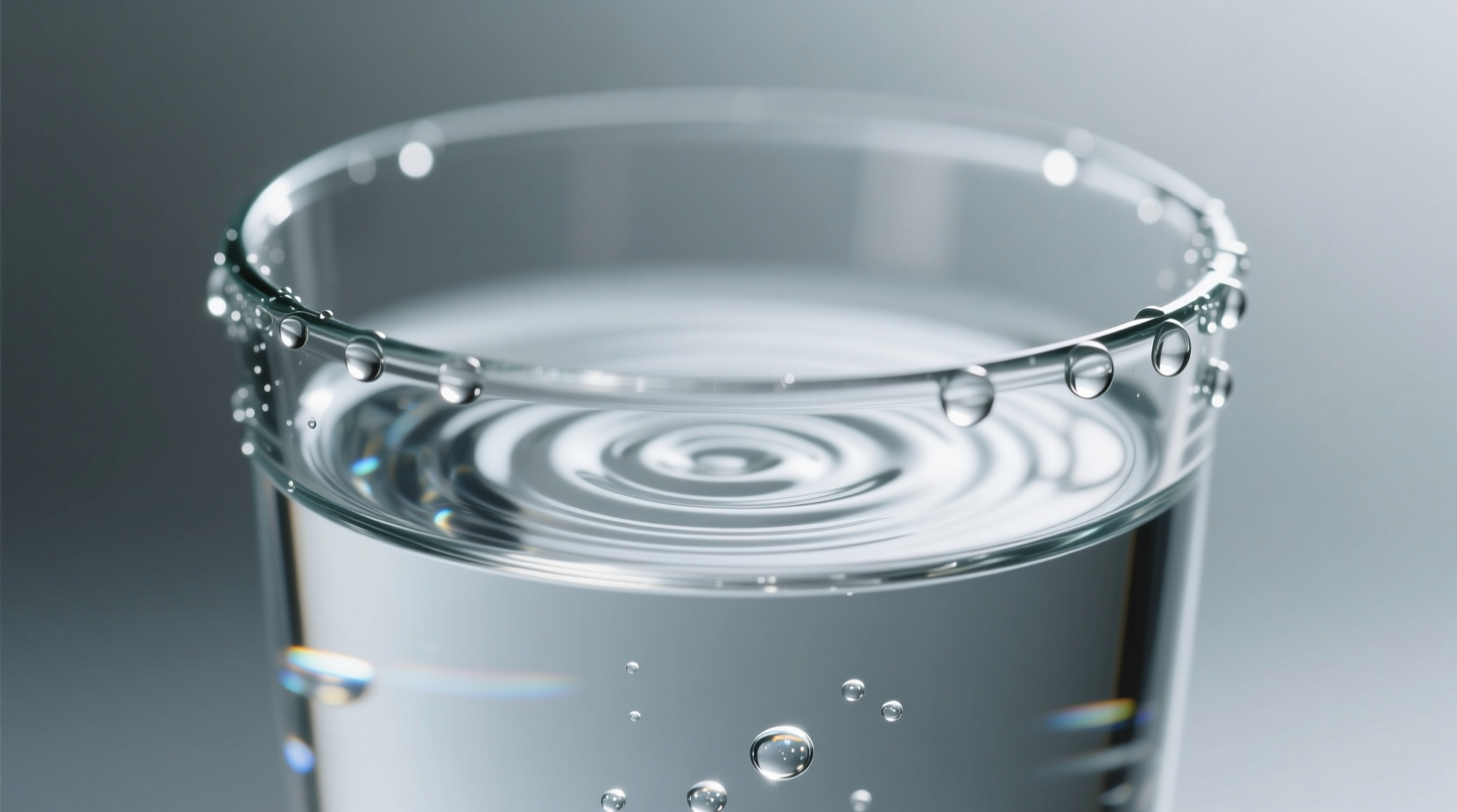 Glass of clear water with droplets on surface