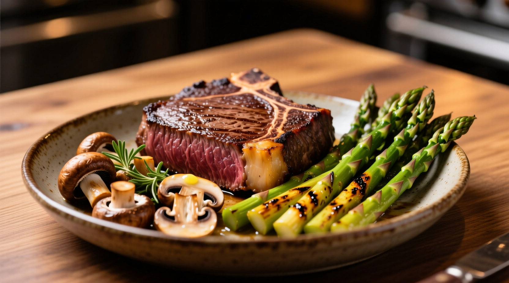 Grilled asparagus and mushrooms beside perfectly cooked steak