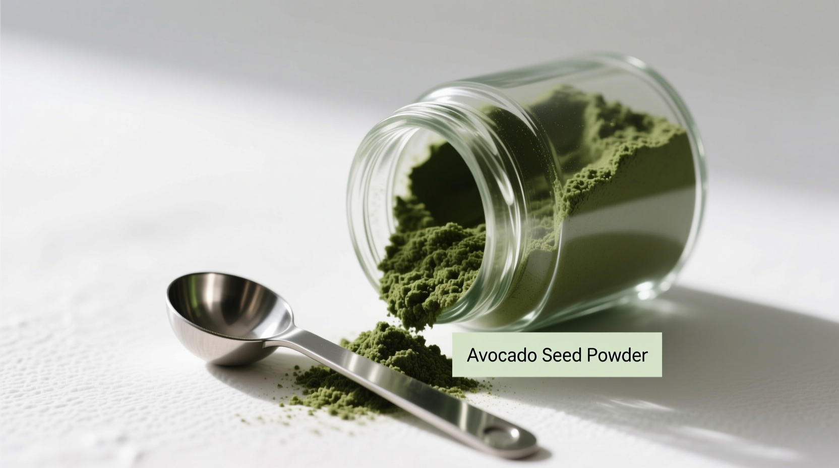 Avocado seed powder in glass container with measuring spoon