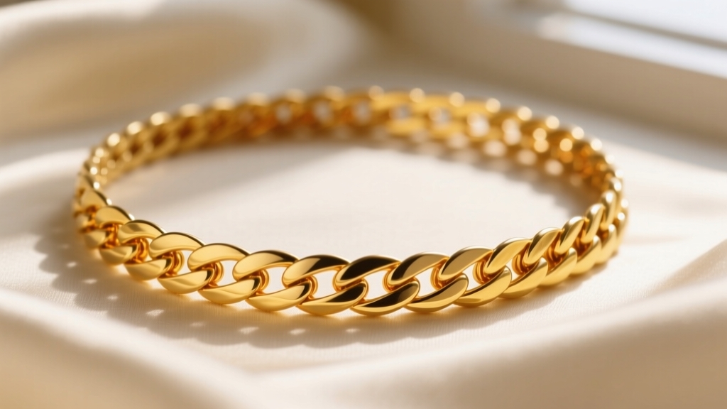 Close-up of 22k gold herringbone necklace showing slight bending and rich yellow patina against soft cream silk fabric background.