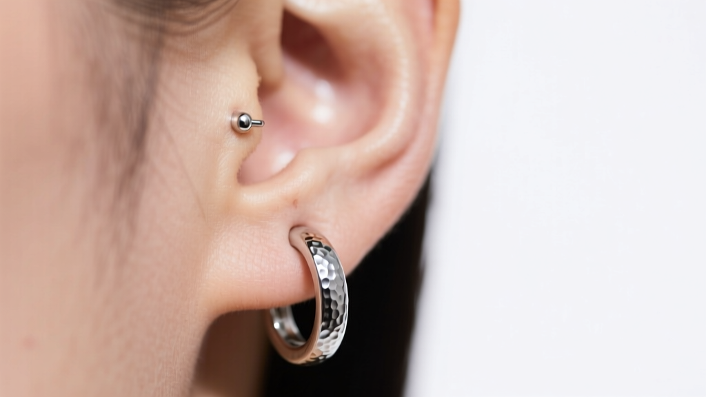 Close up of a 14 gauge 316L surgical steel seamless hoop with a hammered texture, worn on a fully healed ear cartilage piercing