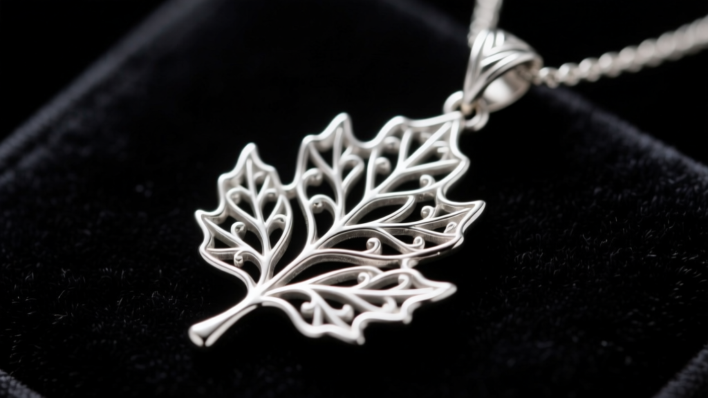 Close-up of an intricately cast sterling silver Galadriel leaf pendant resting on dark velvet, highlighting crisp filigree edges.