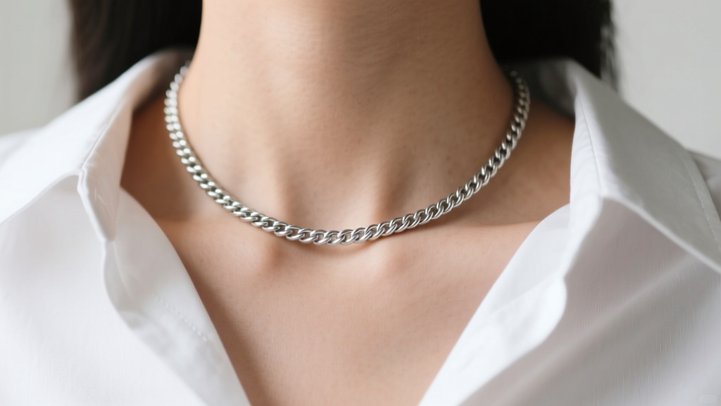 Close-up of a collarbone with a 16-inch silver rope chain resting at the neck base against a crisp white cotton shirt.