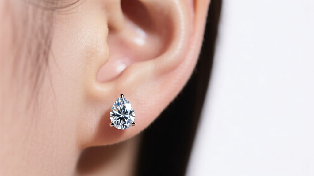 Close-up of a 1.5ct pear-cut diamond stud earring drooping on an earlobe, showing the post gap under soft studio lighting