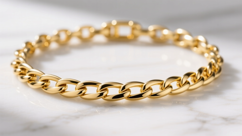 Macro shot of a polished 18k yellow gold Figaro chain necklace showing the alternating link pattern on a white marble surface.