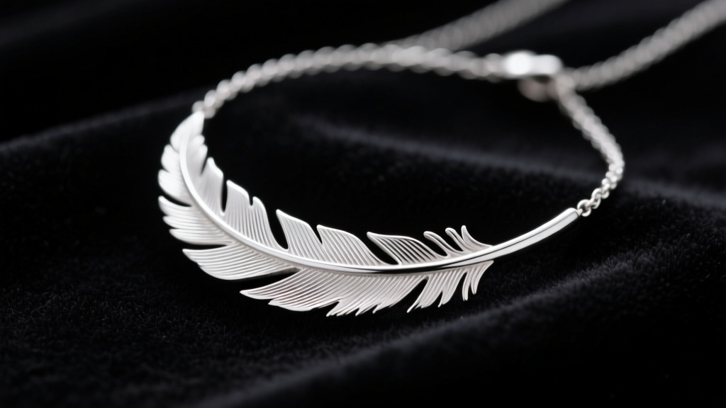 Sterling silver feathered necklace resting on dark velvet, soft studio lighting highlighting intricate metal engraving details