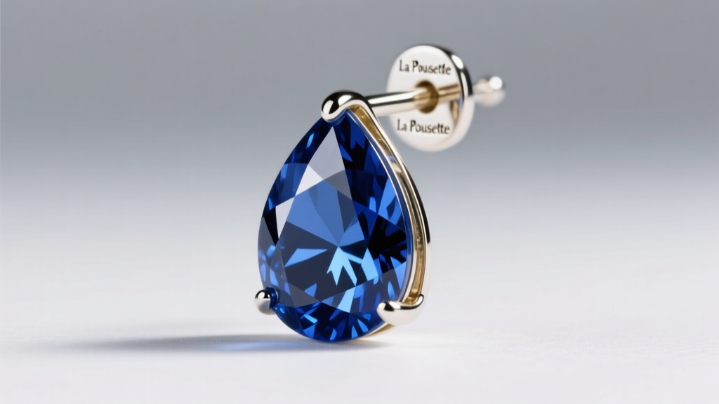 Macro photo of a royal blue sapphire drop earring showing the secure 18-gauge white gold post and a La Pousette locking back.