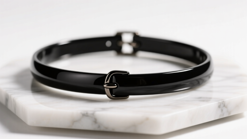 Macro shot of a black plastic tattoo choker necklace on white marble, lit by soft, warm, directional studio lighting for detail.
