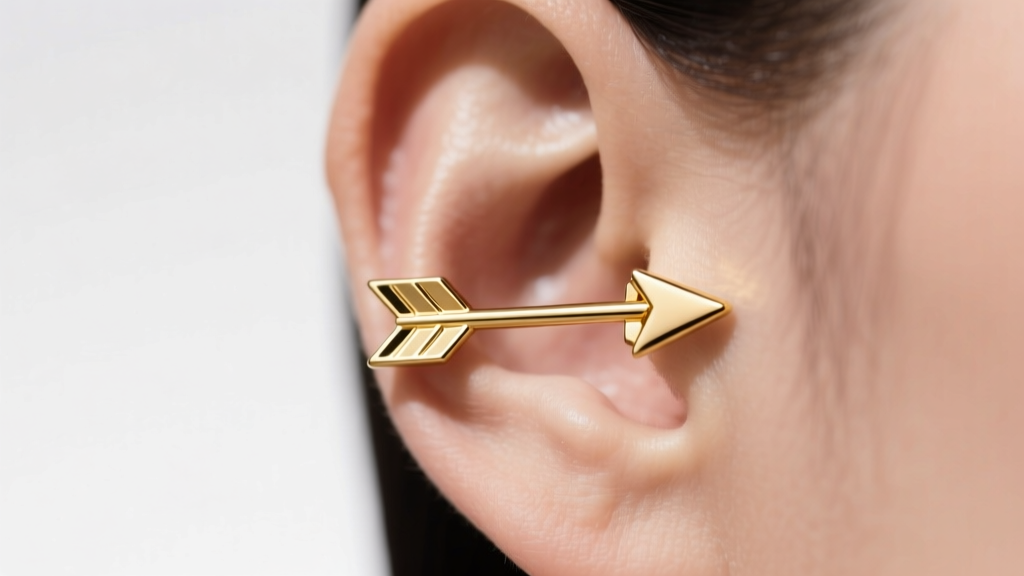Side profile of a 16g gold arrow cartilage earring on a helix, showing proper shaft alignment and a flush flat-back fit.