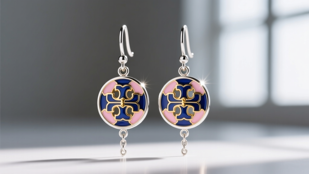 Macro shot of rhodium-plated sterling silver Eleanor drop earrings by Tory Burch, showing intricate enamel and light reflection.