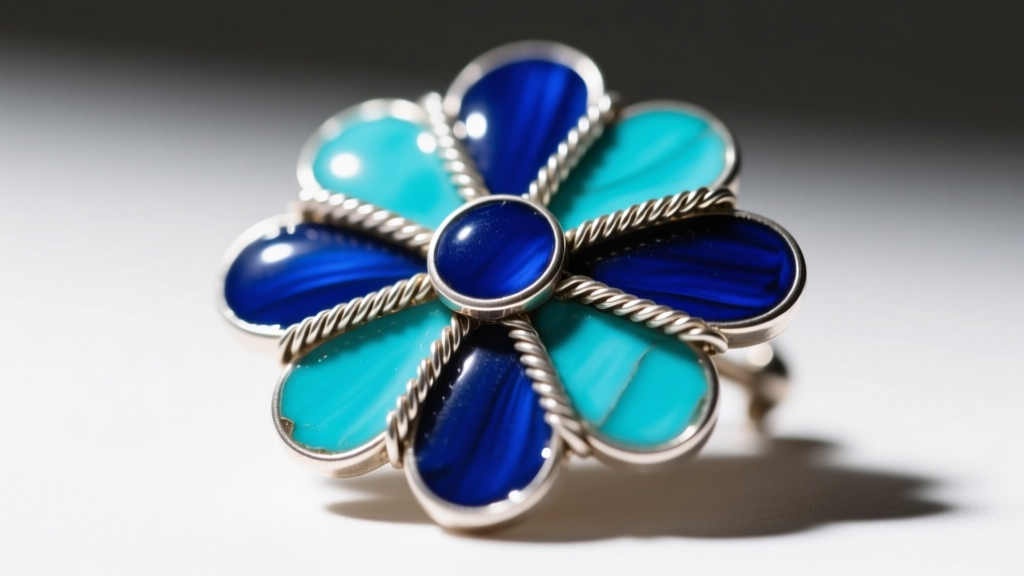 Close-up of antique Russian cloisonne brooch with cobalt blue and turquoise vitreous enamel cells separated by fine silver wires