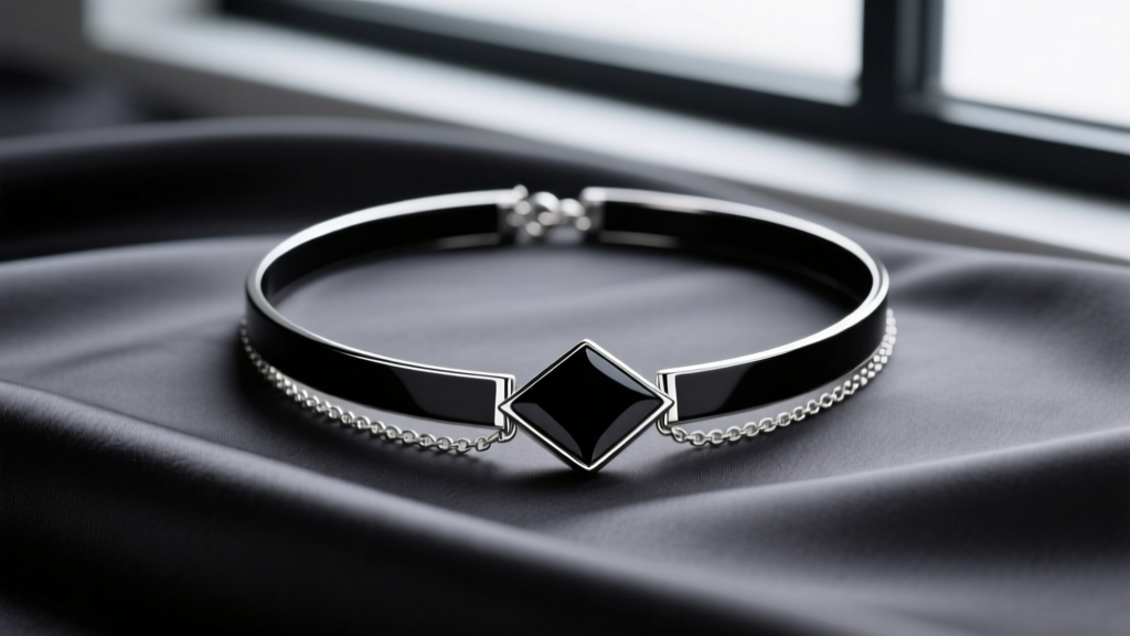Close-up of an elegant black choker necklace made of black rhodium sterling silver resting on dark charcoal silk fabric
