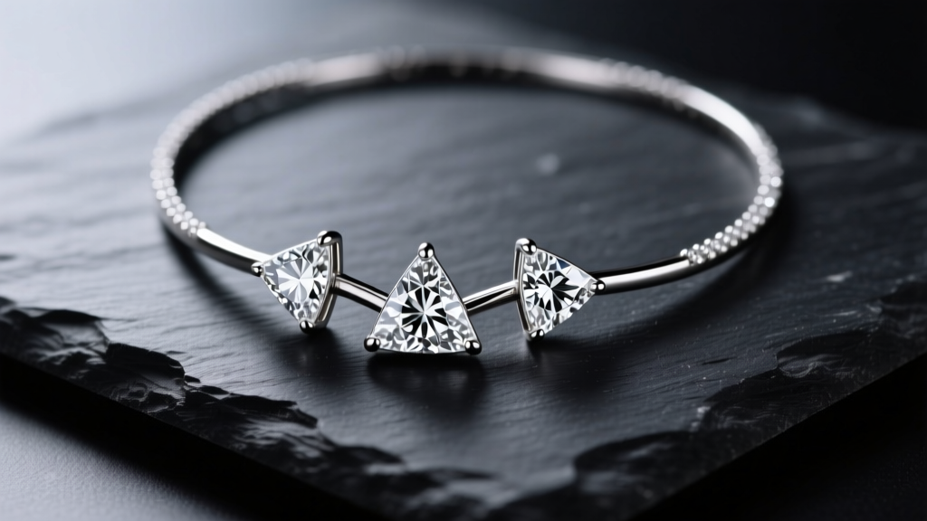 Close-up of a 3 prong tennis necklace on dark slate, highlighting triangular diamond settings under soft studio lighting.