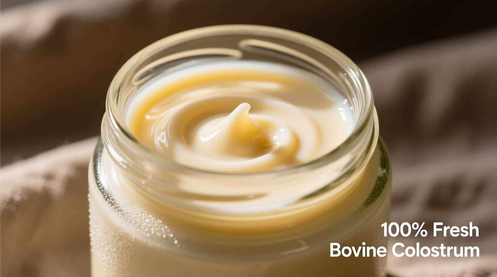 Fresh bovine colostrum in glass container showing creamy texture
