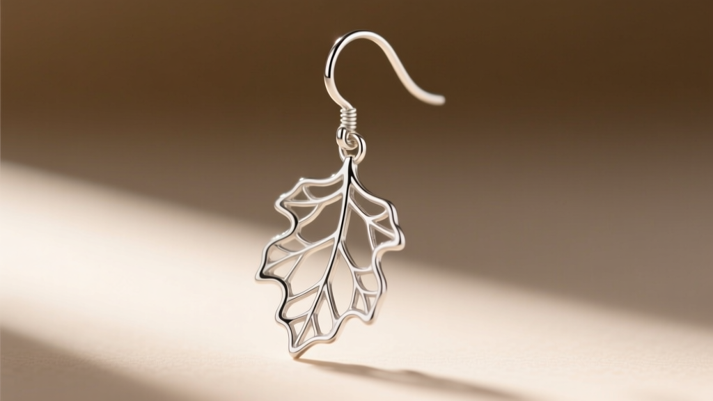 Close-up side profile of a 20-gauge sterling silver ear wire attached to a lightweight, hollow-backed oak leaf dangle earring