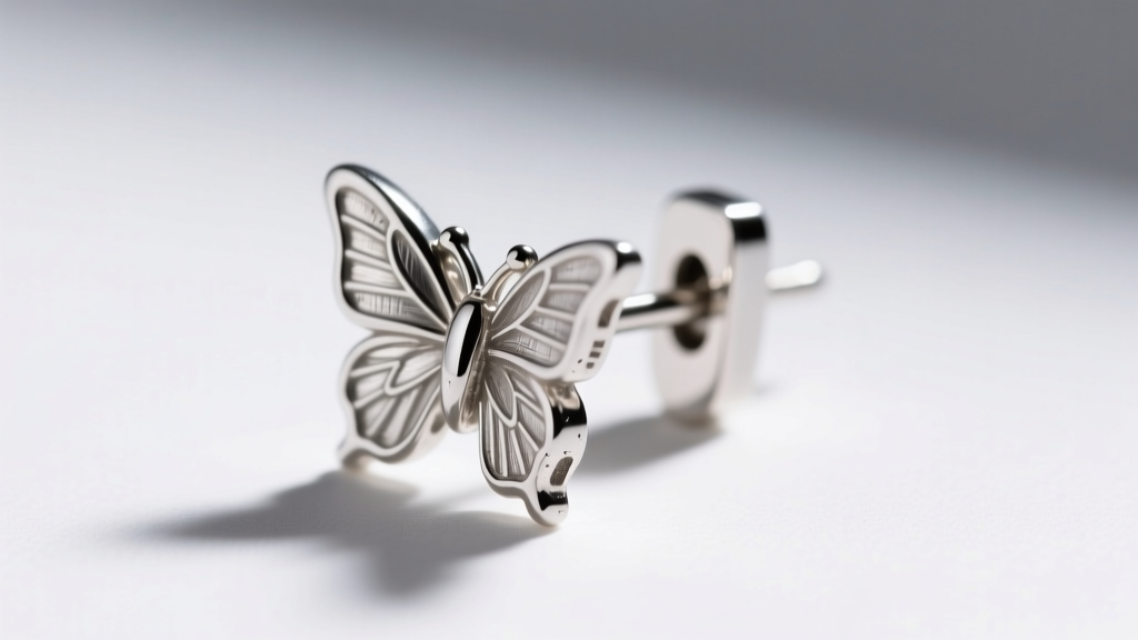 Macro view of a 20-gauge sterling silver earring post and butterfly back, showing fine metal texture and the secure clasp mechanism