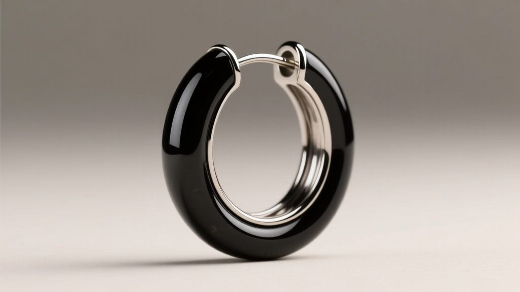 Side profile of an 18-gauge continuous black onyx hoop earring showing the seamless wire insertion and flush bezel stone setting