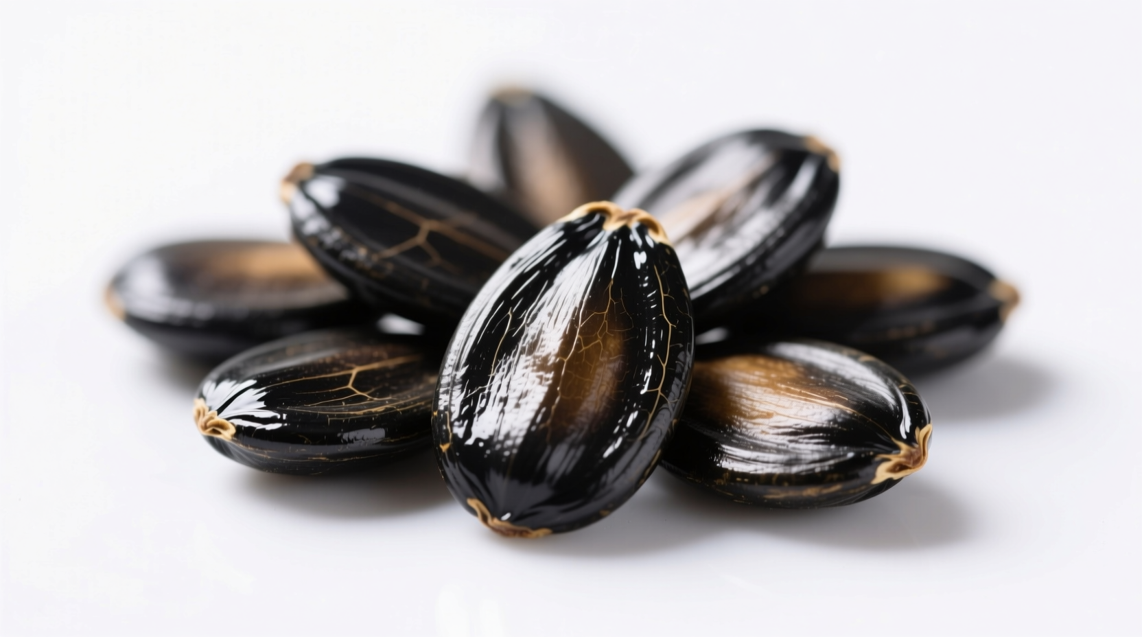 Close-up of black watermelon seeds on white background