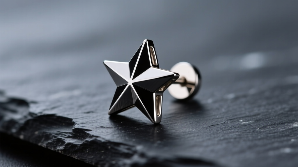 Macro shot of a polished titanium star stud earring on dark slate, showing sharp geometric edges and a mirror-like metal finish.