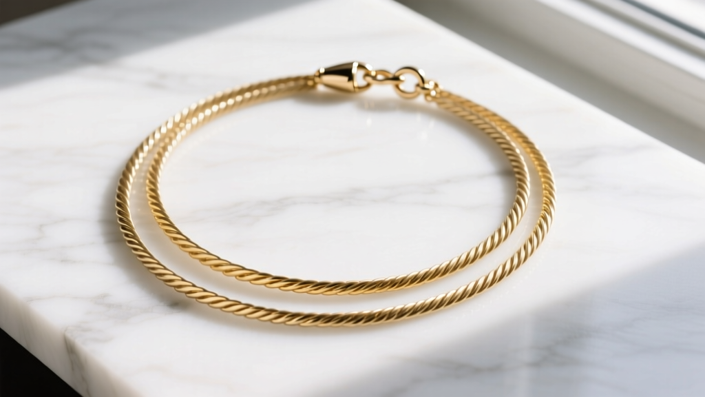 Flat lay of a three-strand gold vermeil multi necklace on white marble, with delicate cable chains and a shiny lobster clasp.