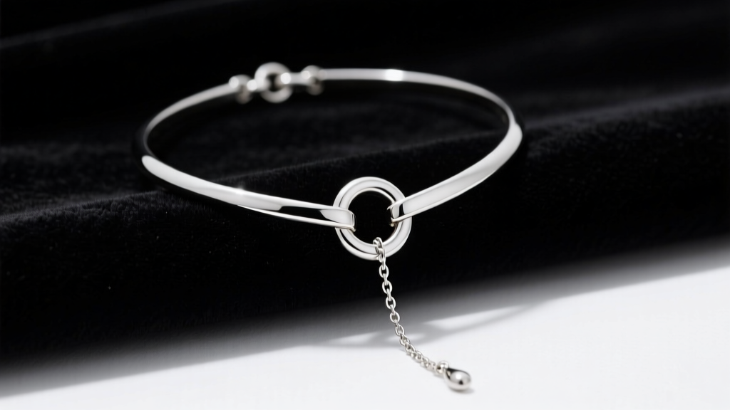 Silver lariat necklace on dark velvet, showing sliding O-ring clasp and Y-drop chain under soft directional studio lighting
