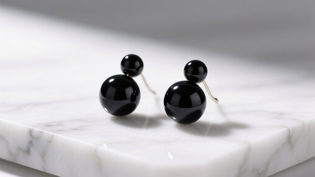 Macro shot of matte black onyx beaded drop earrings resting on white marble, illuminated by soft directional studio lighting