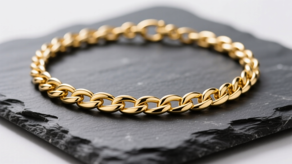 Macro photograph of a 14k yellow gold James Avery wheat chain necklace resting on dark slate, highlighting interwoven links.