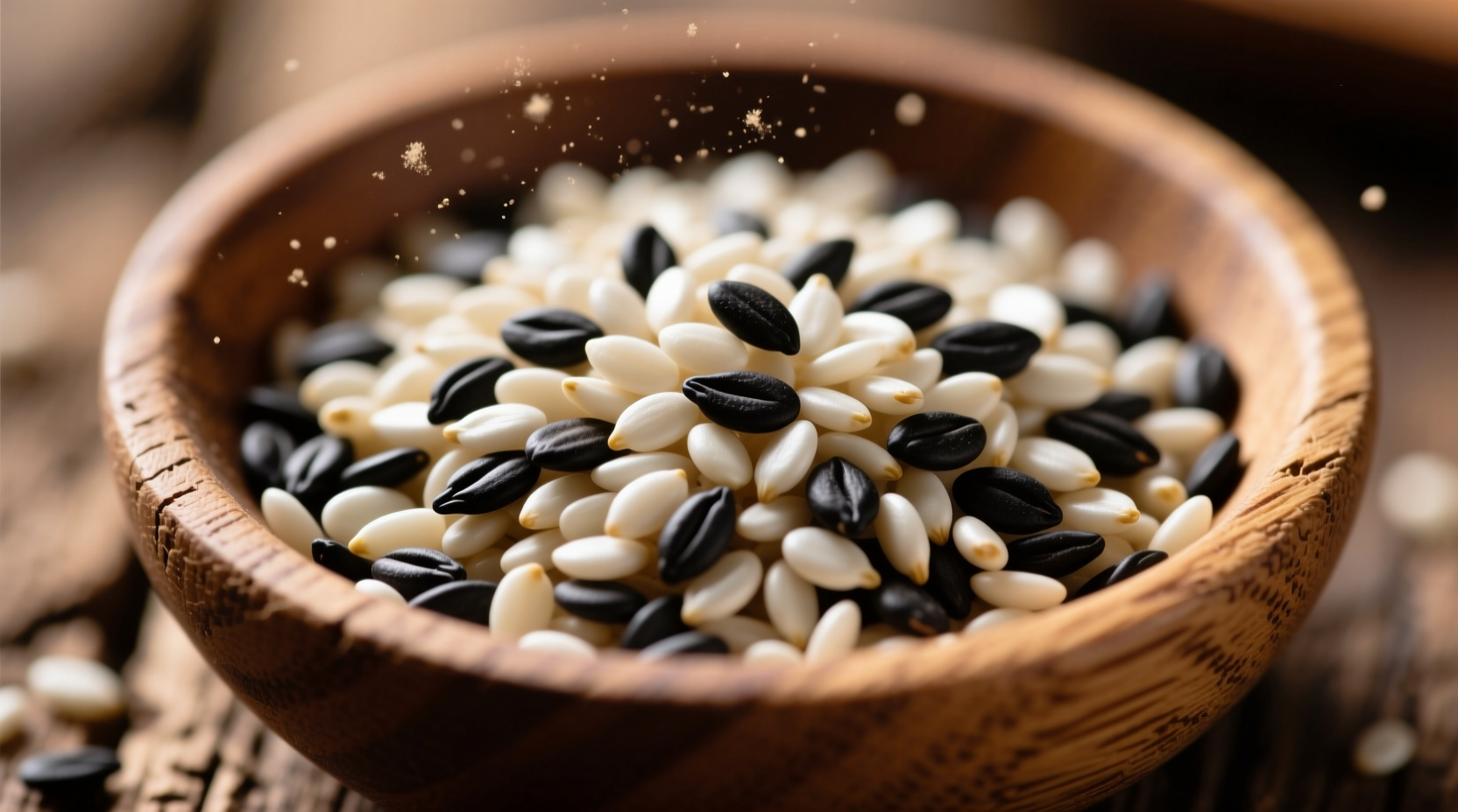 Close-up of white and black sesame seeds in wooden bowl