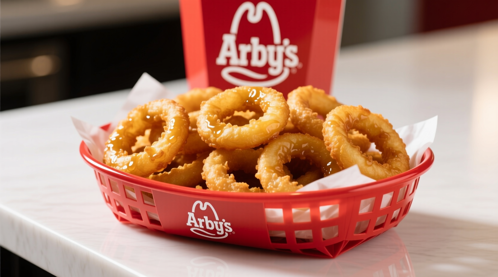 Golden brown Arby's onion rings served in a red basket