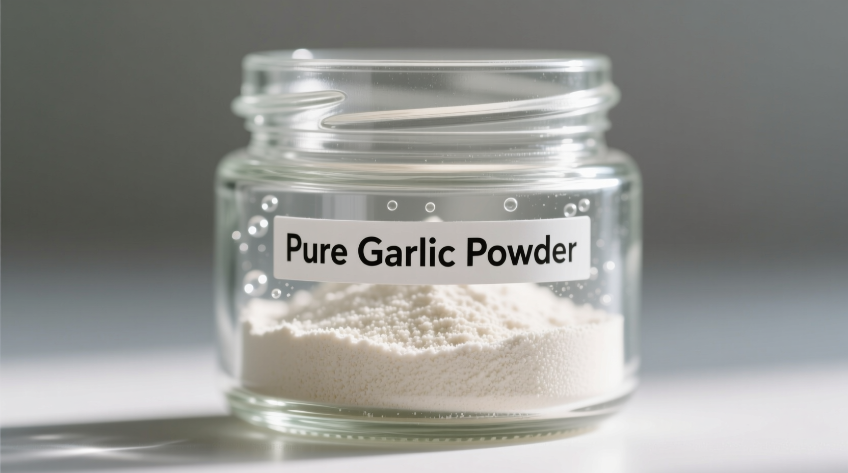 Close-up of pure garlic powder in a glass jar