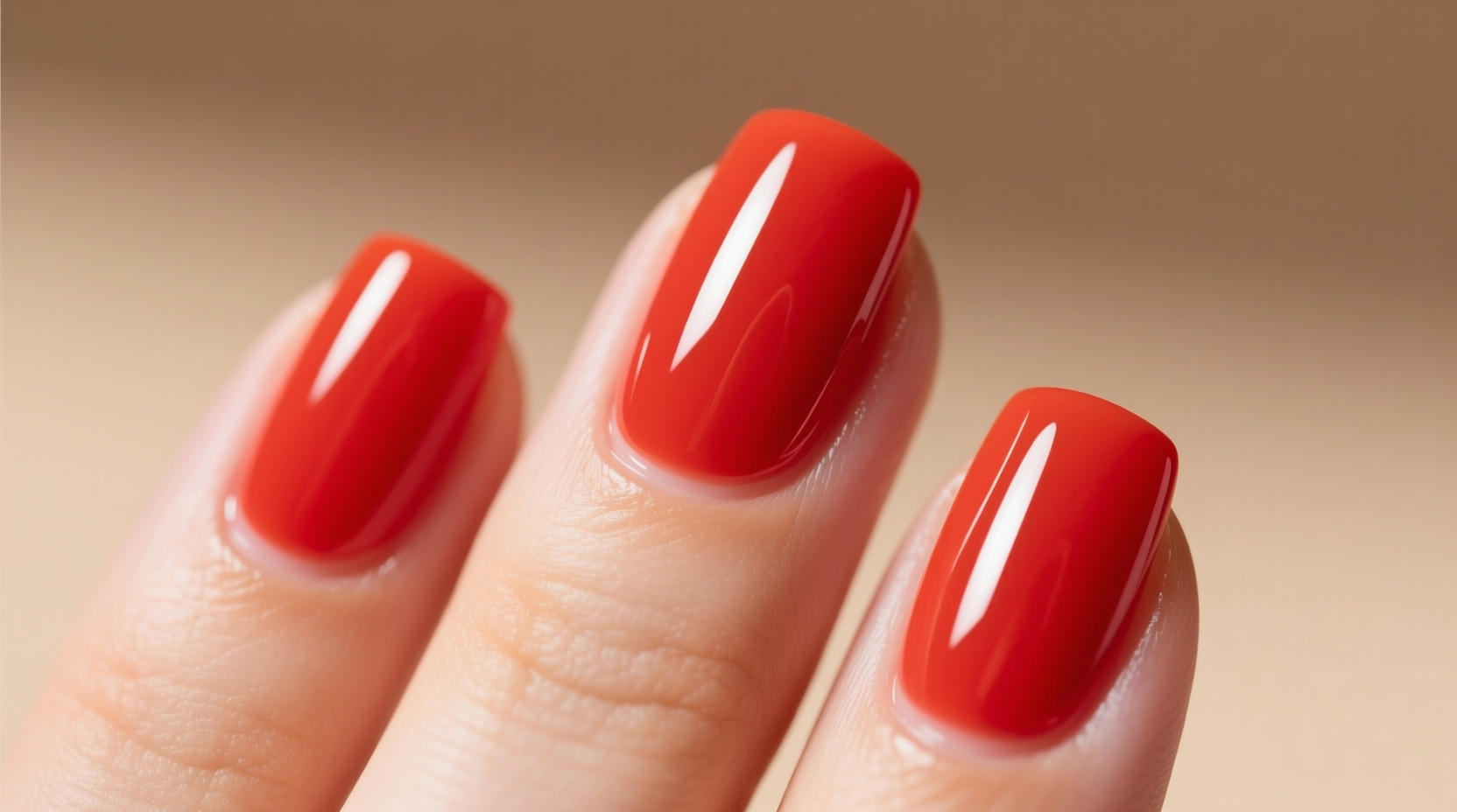 Close-up of perfectly applied tomato nail polish on natural nails