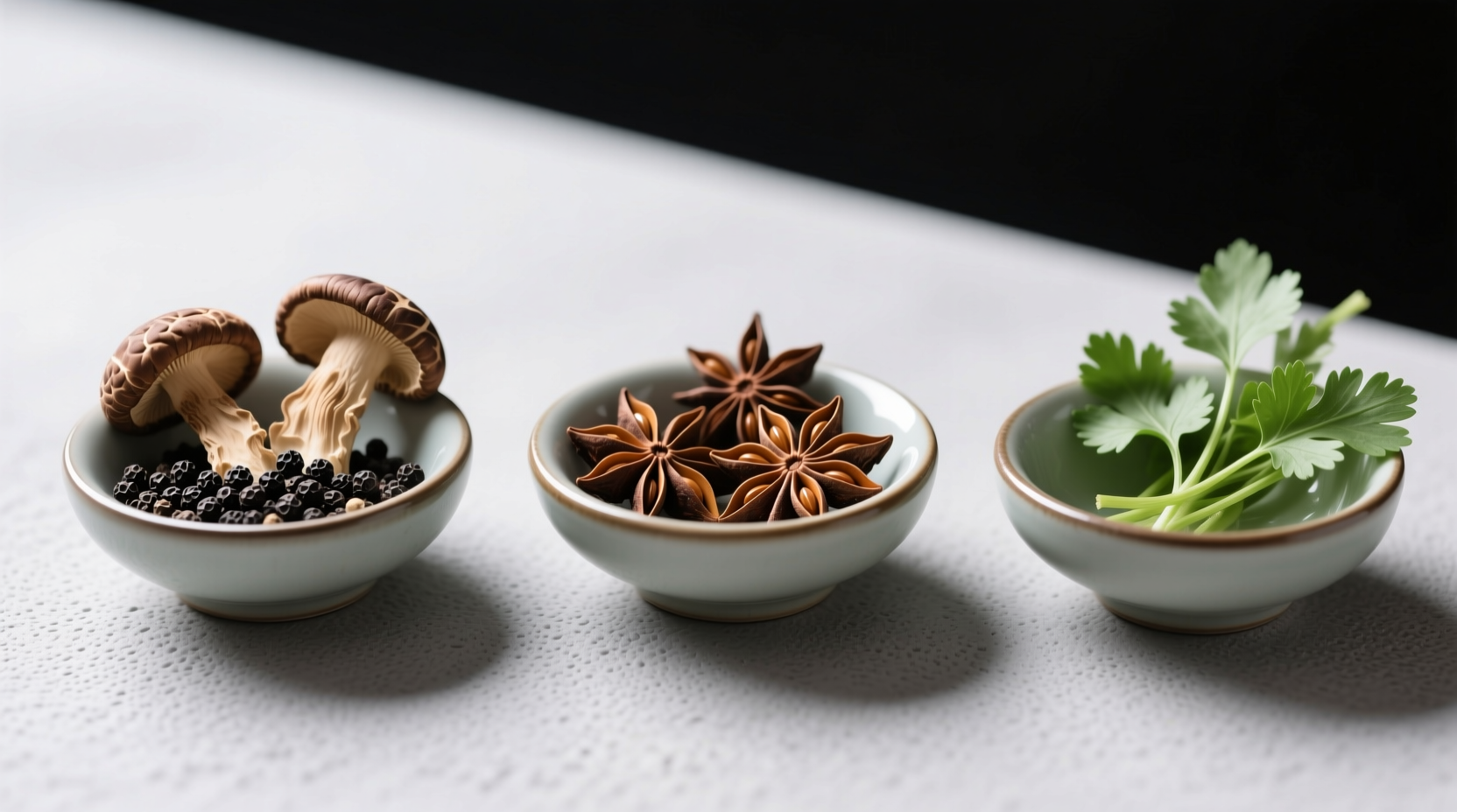 Three small bowls showing spice pairings: dried shiitake with peppercorns, star anise, and cilantro stems