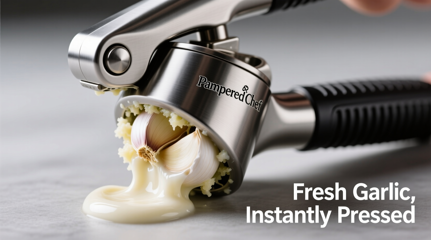 Pampered Chef garlic press extracting fresh garlic pulp