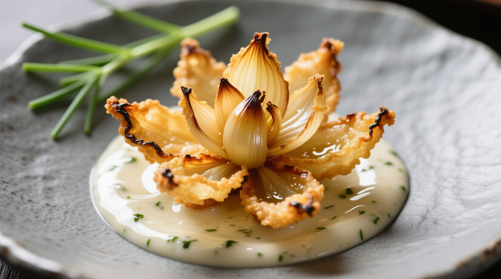 Crispy golden onion blossom appetizer served with dipping sauce