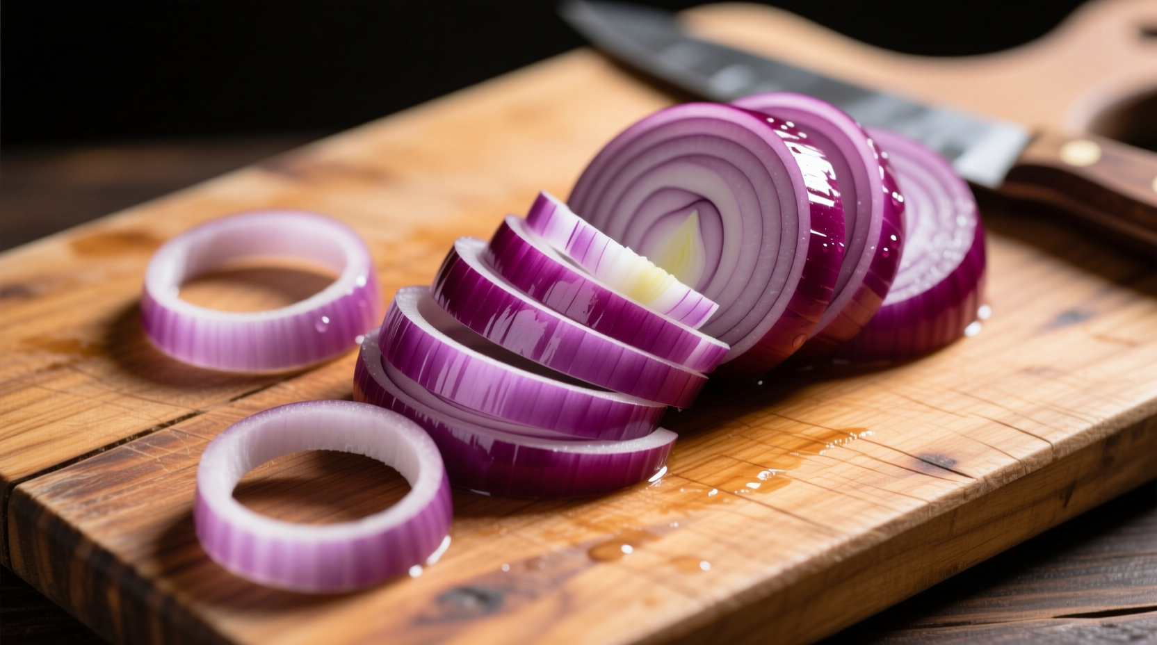 Fresh purple onions arranged on wooden cutting board