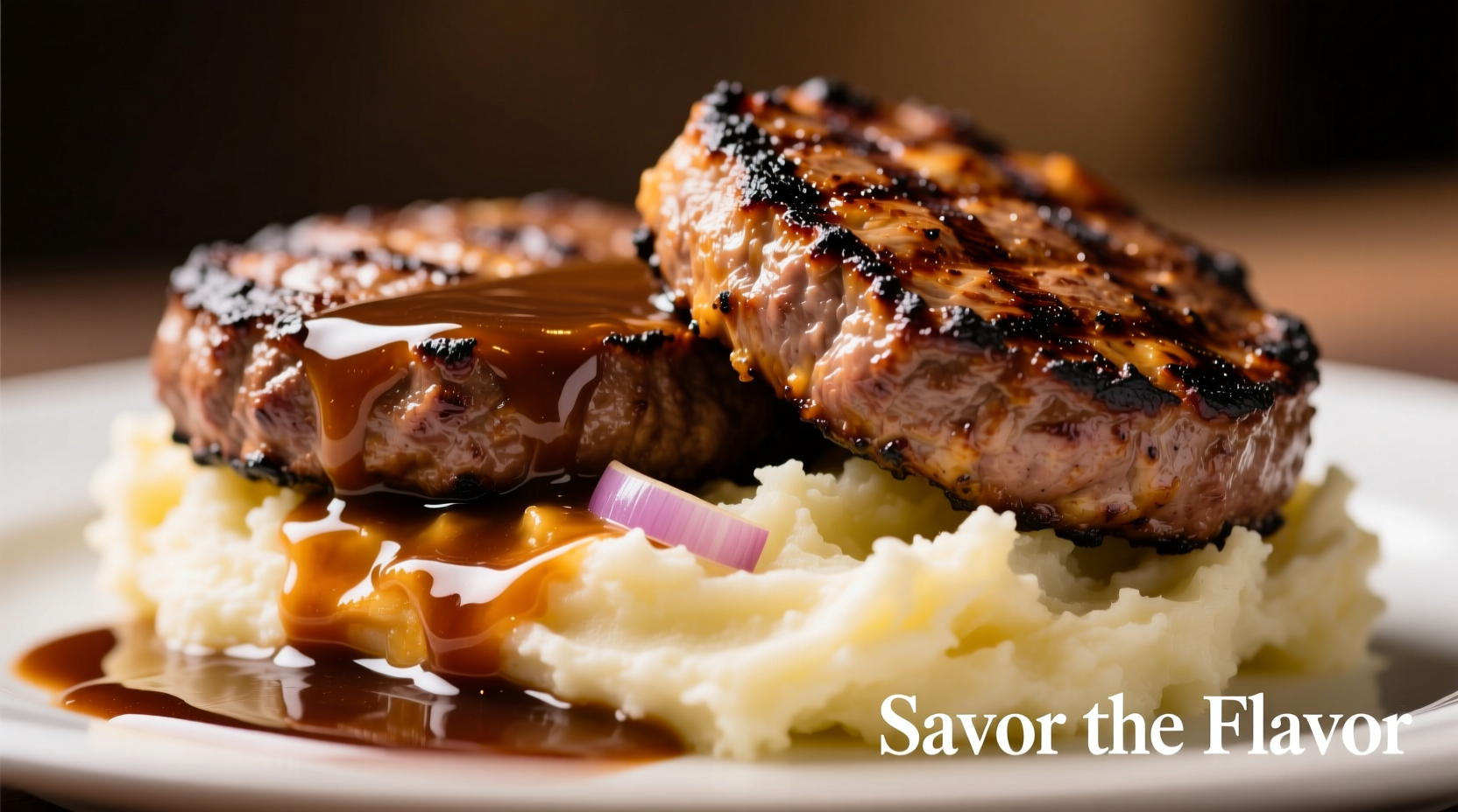 Juicy hamburger steaks with rich onion gravy served over mashed potatoes
