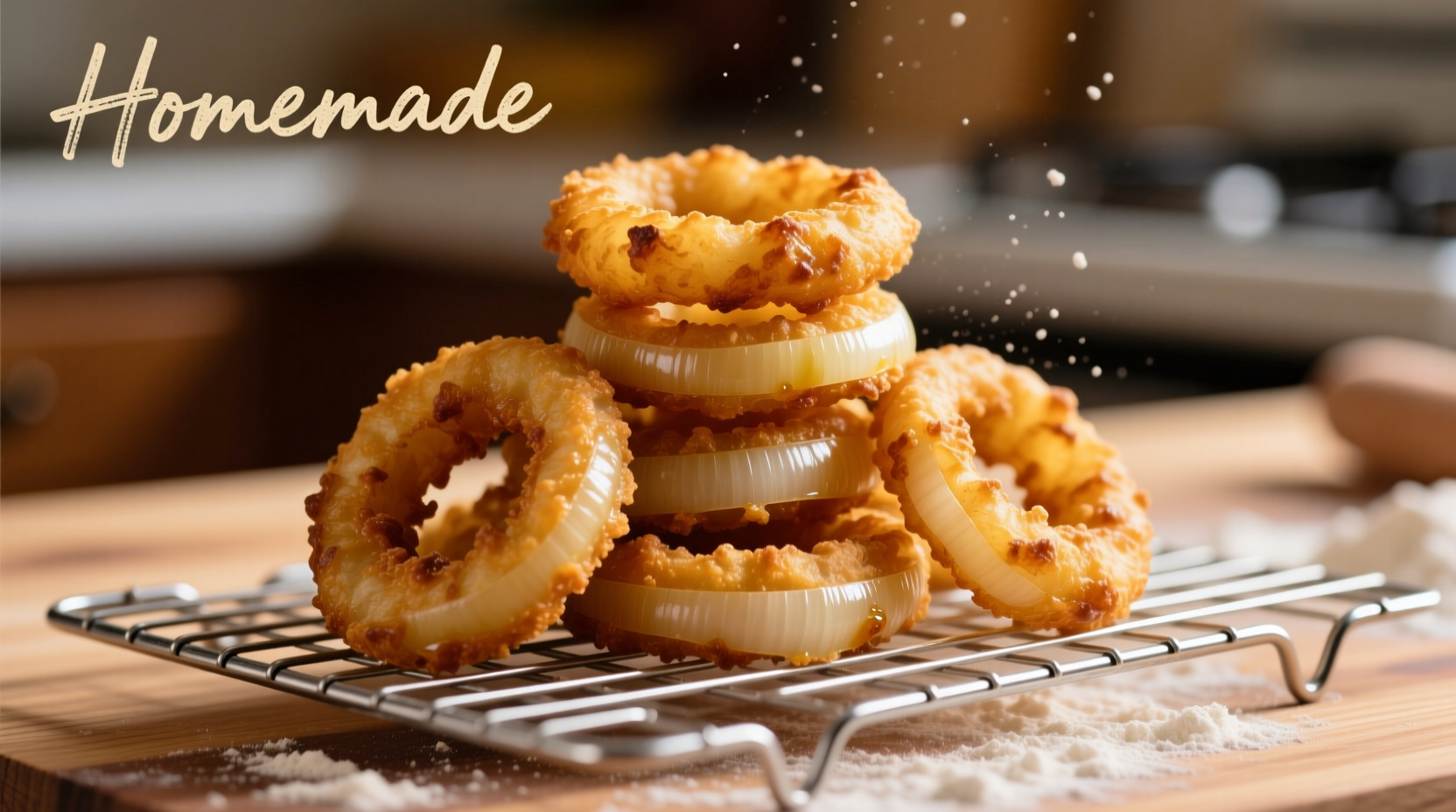 Golden brown homemade onion rings on wire rack