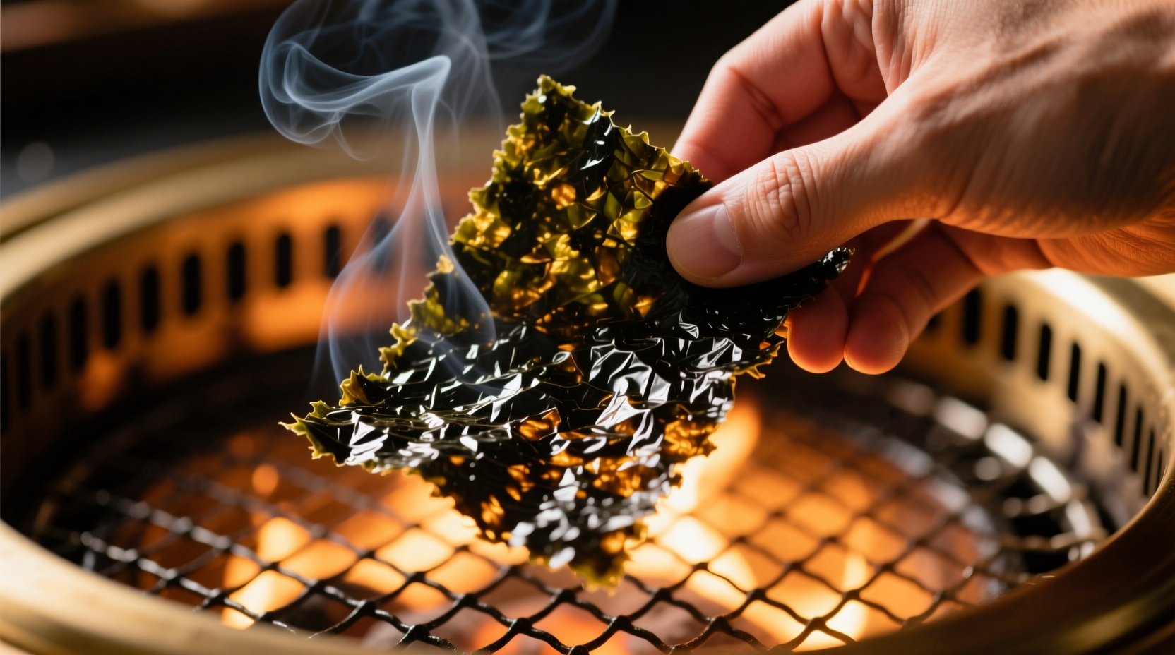 Hand toasting nori sheet under broiler