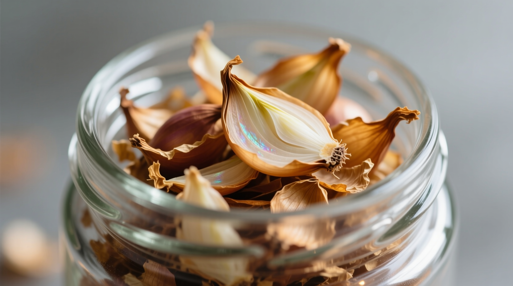 Close-up of dried onion flakes in glass container