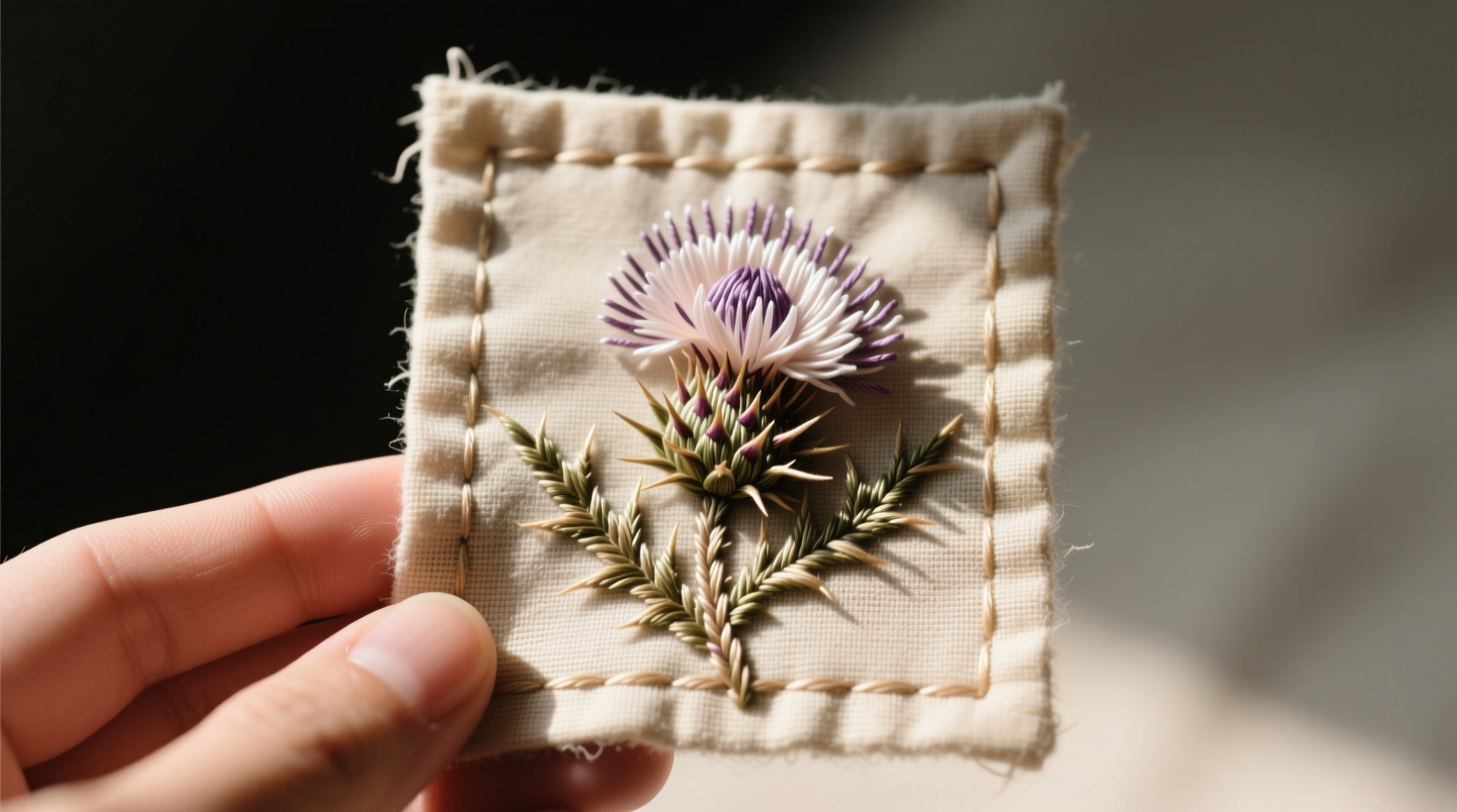 Seasonal Scottish gift guide featuring thistle embroidery on linen, symbolizing resilience for graduation season versus generic flowers