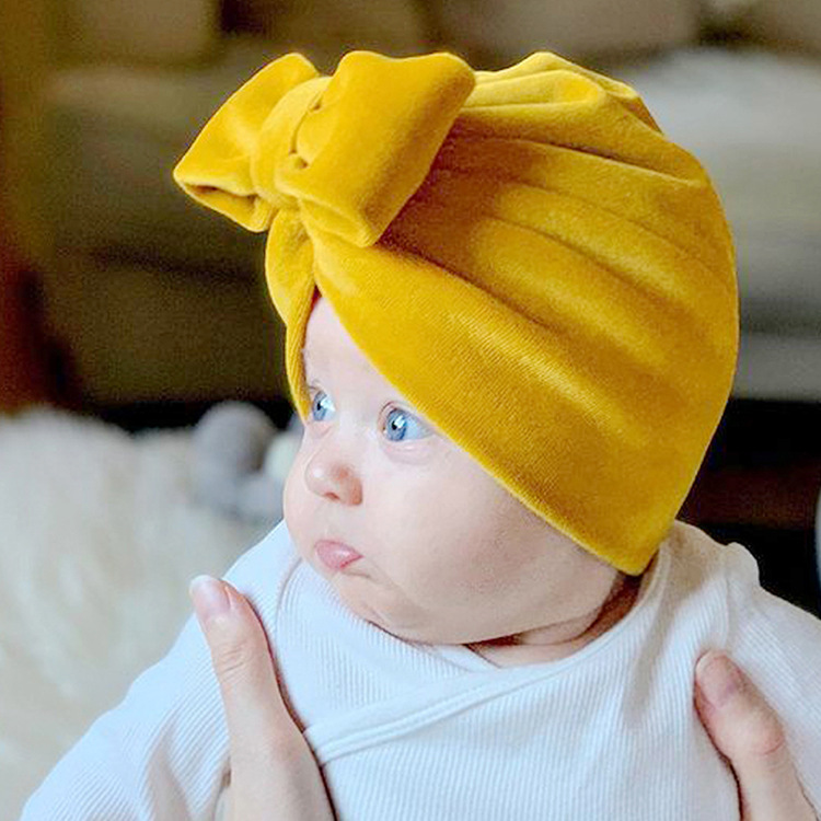 Autumn and winter kids warm hat infant solid color bow flannel pullover hat thickened 8 colors
