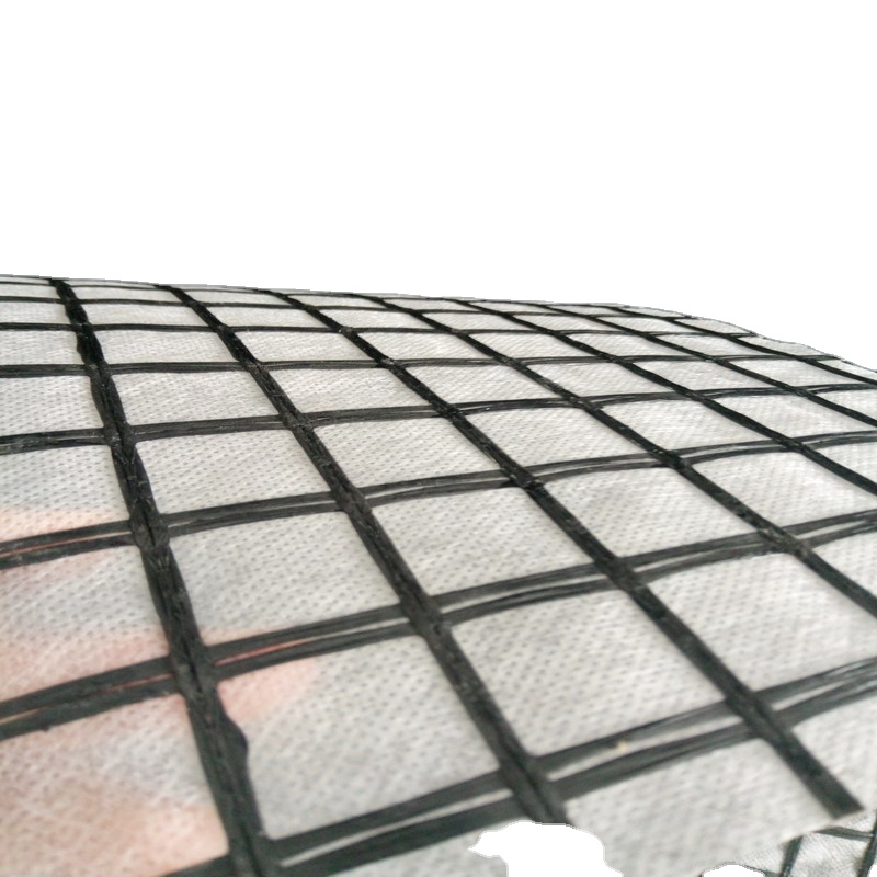 Fiberglass geogrid composite stitched with nonwoven geotextile to reduce reflective cracking