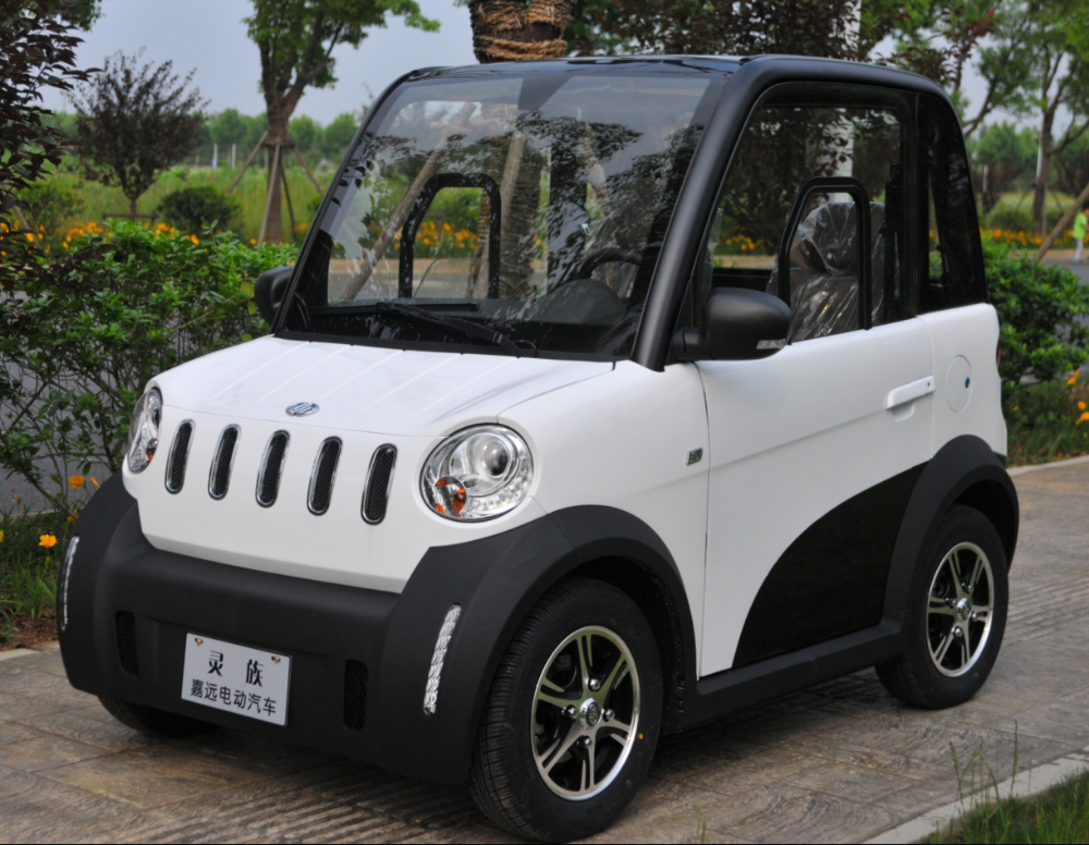China made cheap electric car adults driving in city road