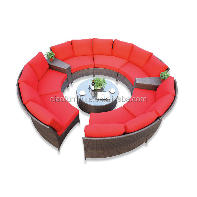 Sectional rattan garden sofa with red cushion