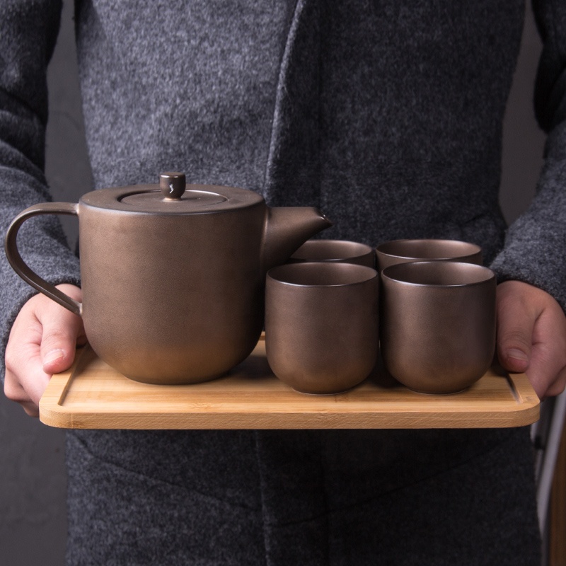 Delicate wine red porcelain tea set, afternoon tea using teapot cups. European coffee pot set with bamboo tray