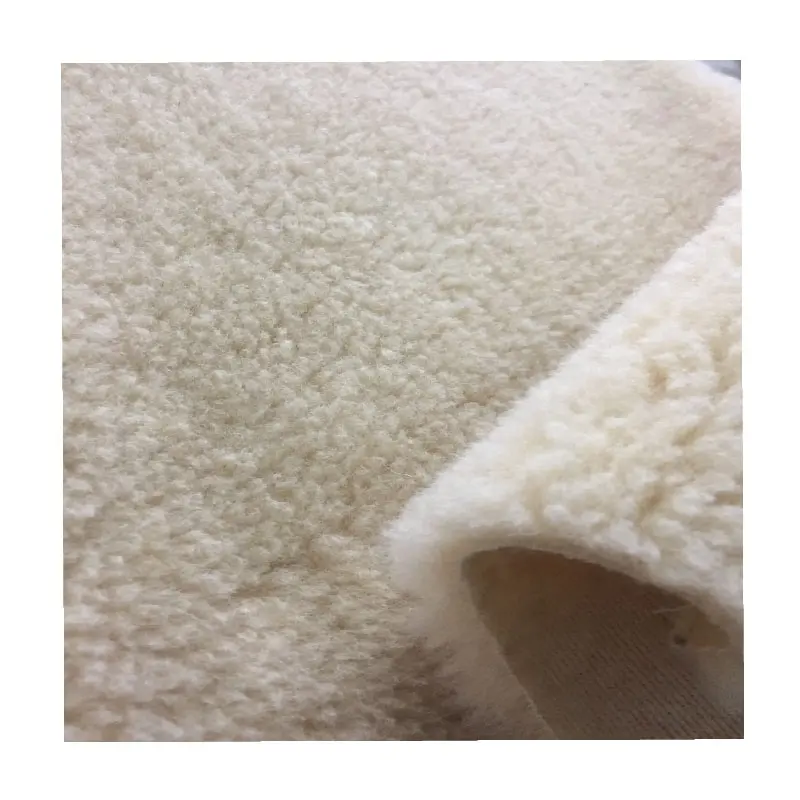 The hair is 100% wool bottom is polyester weft knitting faux lamb fur sherpa wool fabric