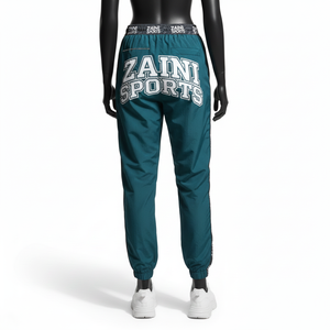 Pantalon coupe-vent pour femme, tissu en nylon tissé de qualité supérieure, couleur sarcelle, design de panneau latéral, logo jacquard personnalisé, pantalon coupe-vent - Product Image 2